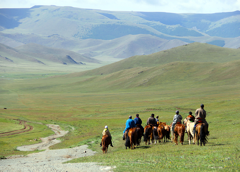 Horse riding in Mongolian steppe